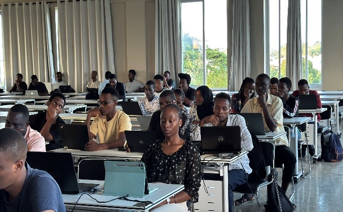 UAUT students working with laptops in a classroom